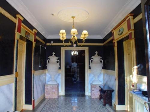a room with a hallway with a chandelier at Posada del Indiano in Cidones