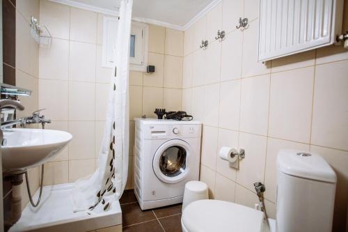 a bathroom with a washing machine and a sink at Luxurious & Modern | Walk Everywhere | 5★ Amenities in Thessaloniki