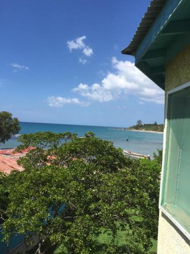 a view of the ocean from a house at Waikiki Guest House in Treasure Beach