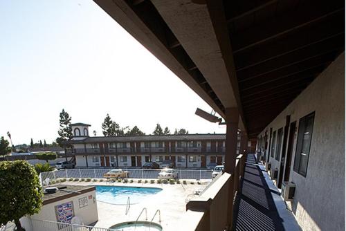 a view of a pool from the balcony of a building at EZ 8 Motel Newark in Newark