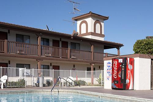 a hotel with a pool and a building with a tower at EZ 8 Motel Newark in Newark