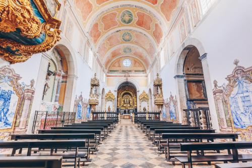 an empty church with rows of pews at Convento do Espinheiro, Historic Hotel & Spa in Évora