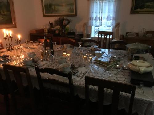 a dining room table with candles and glasses on it at Kromrivier Farm Stays & B&B Near Addo Elephant Park in Paterson