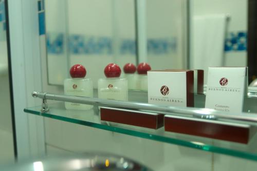 a display of red apples on a glass shelf at Hotel Buenos Aires in Cartagena de Indias