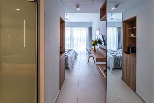 a corridor of a room with a bedroom at Kiani Beach Resort Family All Inclusive in Kalyves