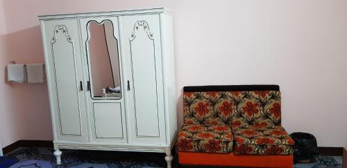a white cabinet and a chair in a room at Nuba Dool in Aswan