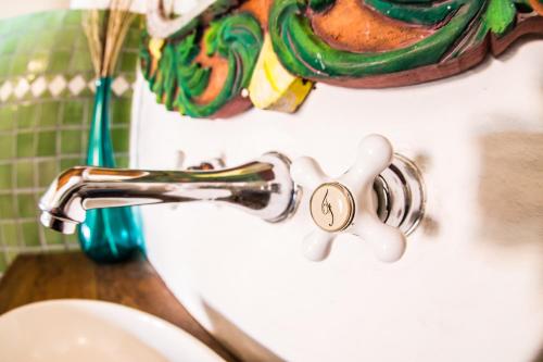 a bathroom sink with a faucet on a sink at Hotel La Casona in Tapalpa