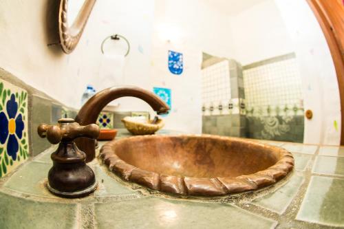 a copper sink in a bathroom with a faucet at Hotel La Casona in Tapalpa