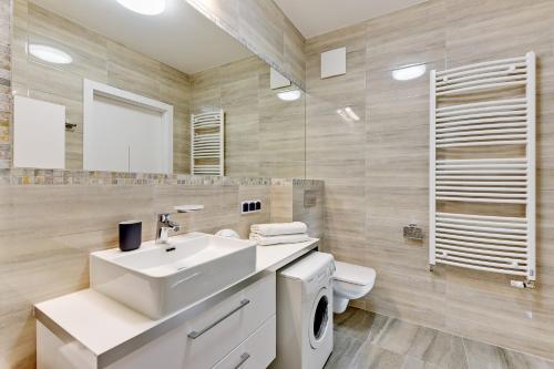 a bathroom with a sink and a toilet and a mirror at Aviator Modern 83 in Gdańsk