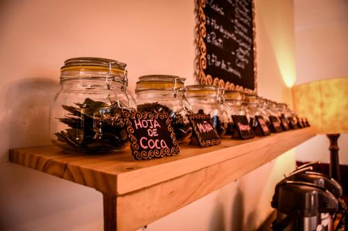 a shelf with several jars of coke on it at Cooper Hotel Boutique in Cusco