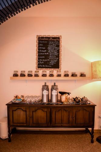 a table with pots and pans on it with a chalkboard at Cooper Hotel Boutique in Cusco