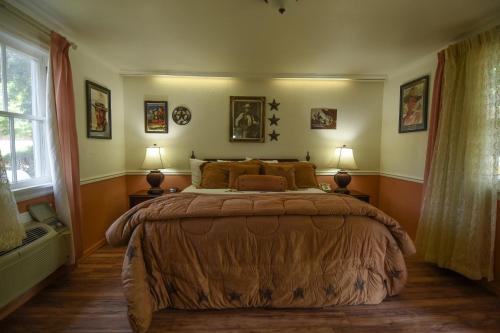 a bedroom with a large bed with two lamps at Parry Lodge in Kanab
