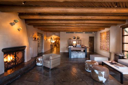 a living room with a fireplace in a house at Rosewood Inn of the Anasazi in Santa Fe