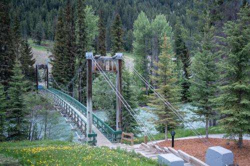 a roller coaster bridge over a river in a forest at Panorama Vacation Retreat at Horsethief Lodge in Panorama