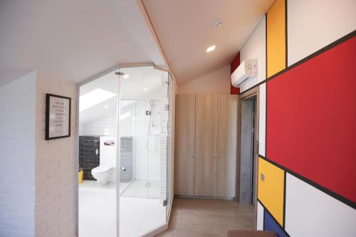 a bathroom with a shower and a toilet at Lavender Inn Guest House in Viešvėnai