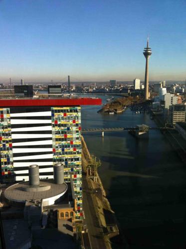 a view of a city with a river and buildings at INNSiDE by Meliá Düsseldorf Hafen in Düsseldorf