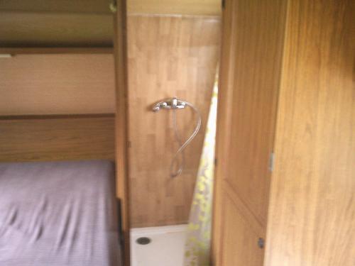 a small room with a bed and a closet at ferme pedagogique des pennetieres in Montcorbon