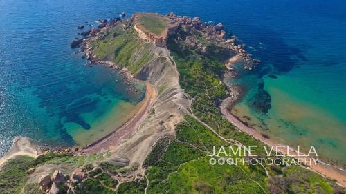 an aerial view of a small island in the ocean at Artist Terrace Apartments in Mellieħa