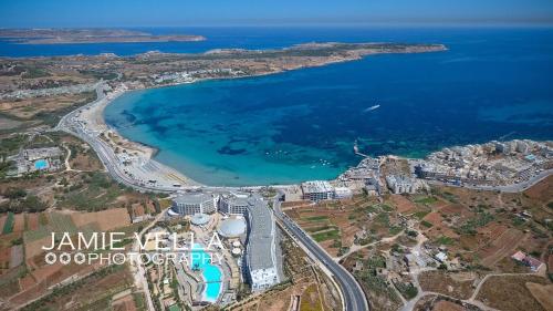 an aerial view of a beach and the ocean at Artist Terrace Apartments in Mellieħa