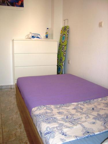 a bedroom with a bed and a dresser at Apartment for Family 2 in Kallithea Halkidikis