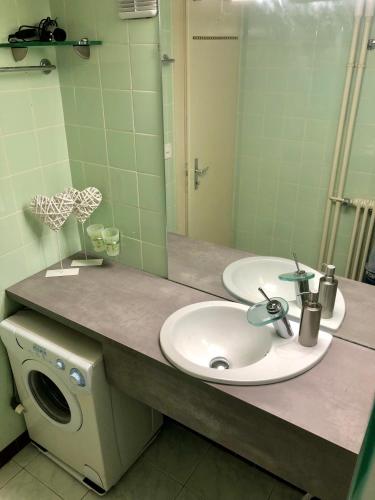a bathroom with a sink and a washing machine at Lake & Mountain View Apartment I 27 in Montreux