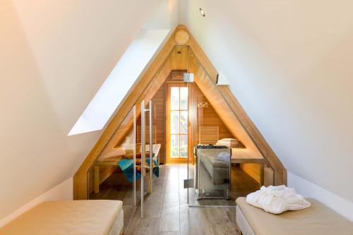 a attic room with two beds and a staircase at Strandgut 3 in Westerland
