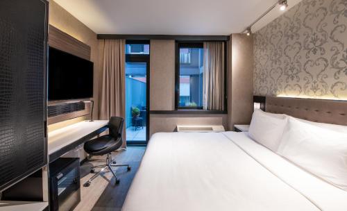 a hotel room with a bed and a desk at Aliz Hotel Times Square in New York