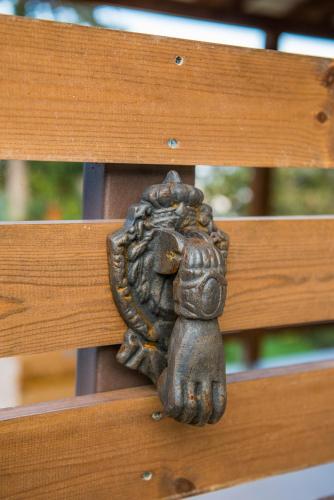a statue of a squirrel on a wooden bench at Anotopos in Ano Trikala