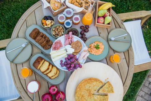 a table with a bunch of breakfast foods on it at Anotopos in Ano Trikala