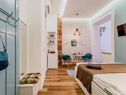 ブダペストにあるThe Blue - studio apartment in the center of Budapestのベッドルーム1室(ベッド1台、テーブル、椅子付)