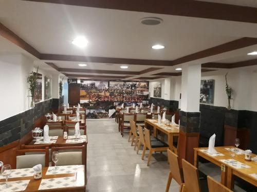 a dining room with wooden tables and chairs at Hotel Del Parque in La Ceja