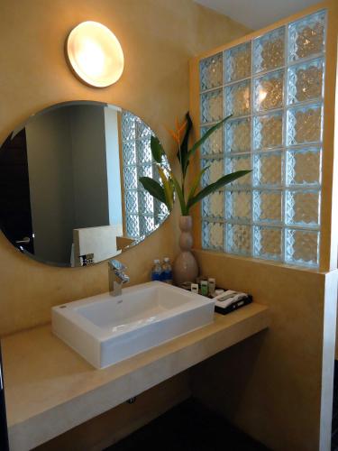 a bathroom with a sink and a mirror at MEN's Resort & Spa (Gay Hotel) in Siem Reap