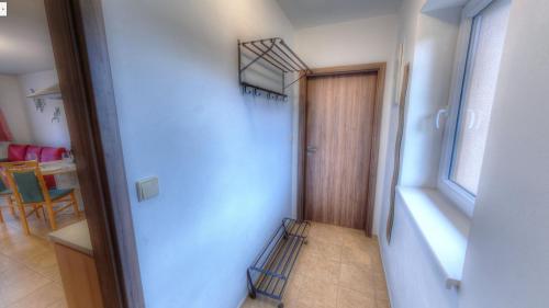 a hallway with a staircase in a room with a door at Apartmány Nad rybníky in Horní Planá