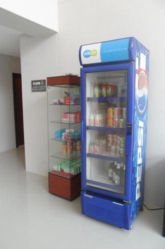 a blue refrigerator with food inside of it at Pangviman Place Resotel SHA Plus in Chiang Mai
