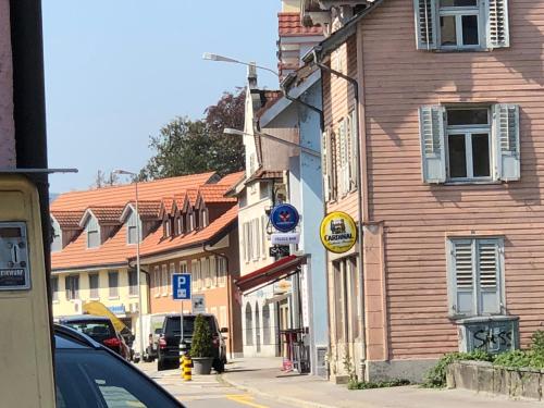 a street in a town with a wooden building at SASS APARTHOTEL in Schönenwerd