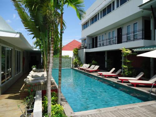 a resort swimming pool with lounge chairs and a hotel at MEN's Resort & Spa (Gay Hotel) in Siem Reap