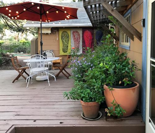 a patio with a table and chairs and an umbrella at Merrynook in Pinehurst