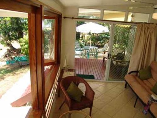 a living room with a couch and a sliding glass door at Seachange Lodge in Port Vila