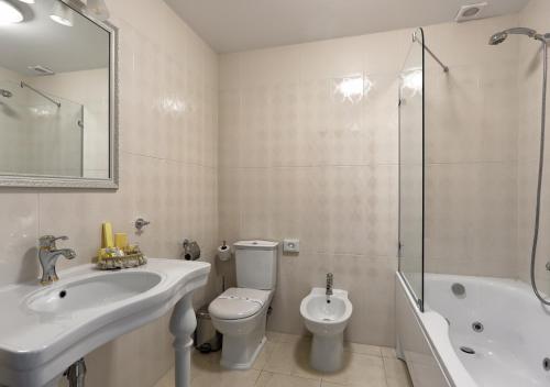 a bathroom with a sink and a toilet and a shower at FENIX TOWN in Vinnytsya