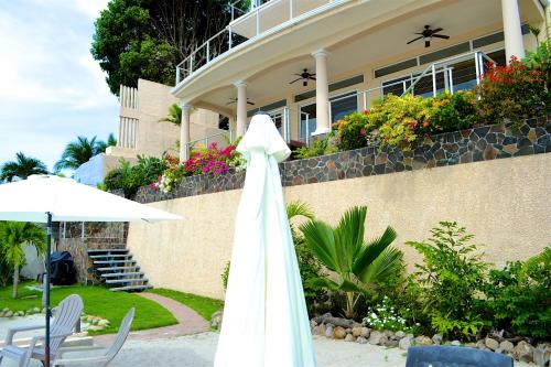 a white dress hanging on the side of a house at Casa Caracol in Playa Coronado