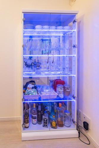 a refrigerator filled with lots of dishes and glasses at Villa de Class in Osaka