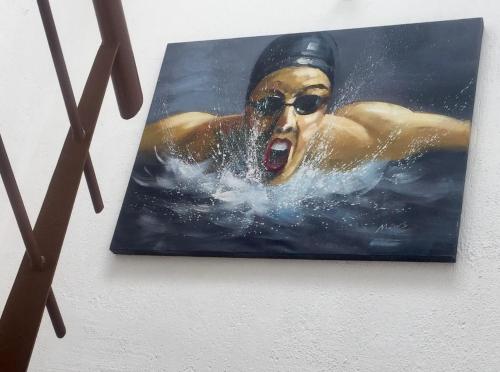 a painting of a man swimming in the water at Residence Las Trojes Cdmx in Mexico City