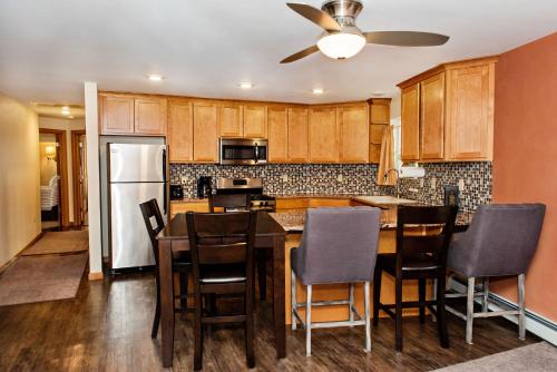 a kitchen with a table and chairs and a refrigerator at Red Wing Motel in Manitou Springs