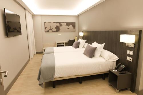 Tempat tidur dalam kamar di Hotel Cruz de la Victoria