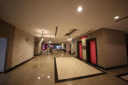 a hallway of a building with a rug on the floor at Sunshine Vista Hotel in Pattaya Central