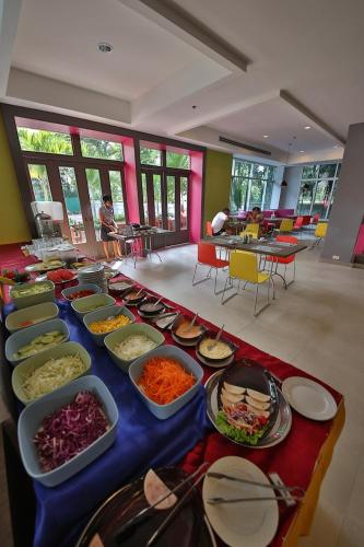 a buffet of food on a table in a room at Sunshine Vista Hotel in Pattaya Central
