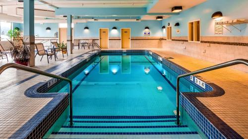 a swimming pool with stairs in a building at Best Western Williams Lake in Williams Lake