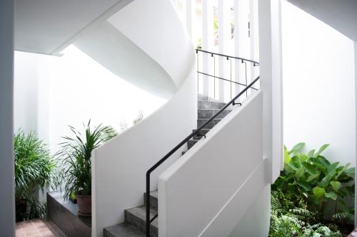 a white staircase in a house with plants at Viroth's Villa in Siem Reap
