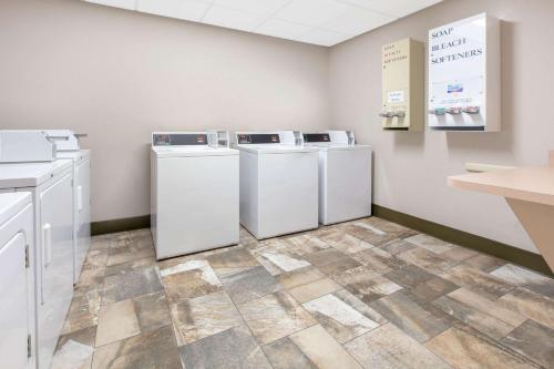 a laundry room with white washers and dryers at Super 8 by Wyndham Page/Lake Powell in Page