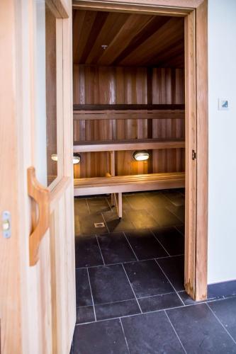 an empty closet with a wooden door and a tile floor at The Sebel Melbourne Malvern in Melbourne